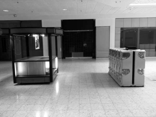 Century III shopping mall common area with empty kiosk and candy machines