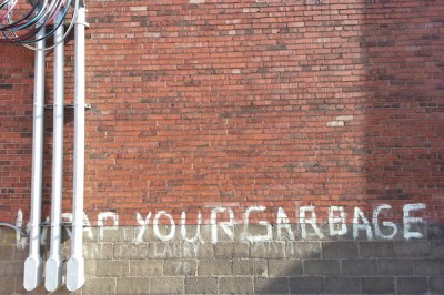 "Wrap Your Garbage" painted on side of building in Lawrenceville