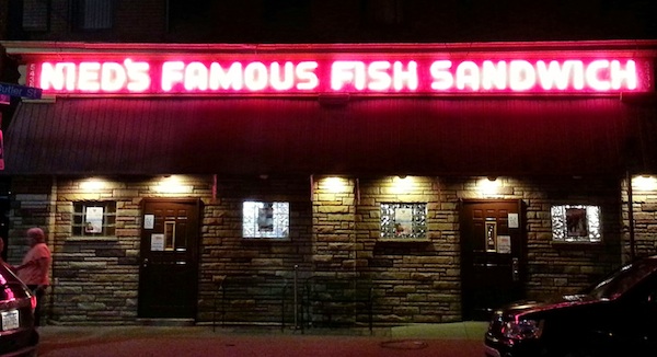 Nied's Famous Fish Sandwich bar/restaurant with glowing neon sign at night