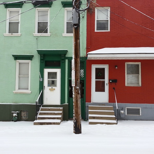 Two rowhouses in the Bloomfield neighborhood of Pittsburgh: one green, one red