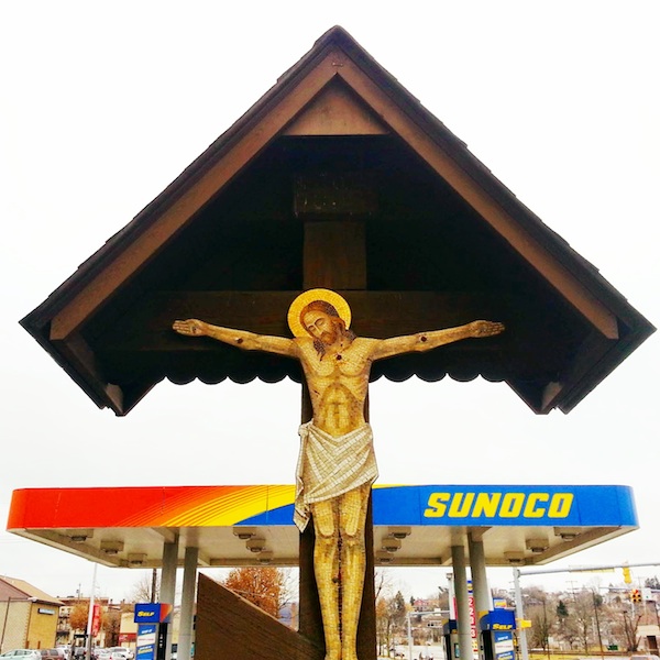 Crucifixion scene with Sunoco gas station in background