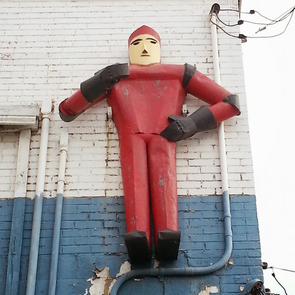 Figure of a man created from steel parts on wall of Mars Builders Supply, McKeesport, PA