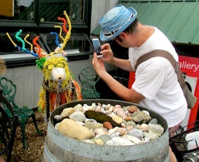 Orbit photographer taking picture of colorful deer sculpture