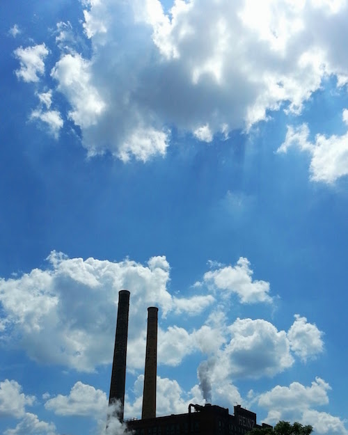 Heinz factory smokestacks silhouette with blue sky and white clouds, Pittsburgh, PA