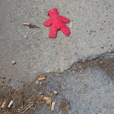 stuffed red toy in street