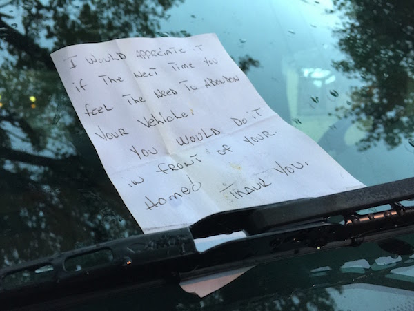 Note left on car's windshield reading "I would appreciate it if the next time you feel the need to abandon your vehicle you would do it in front of your home. Thank you."