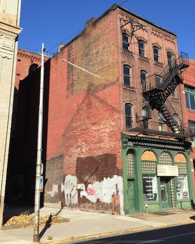 4-story brick building with outline of 2-story "ghost house", Pittsburgh, PA