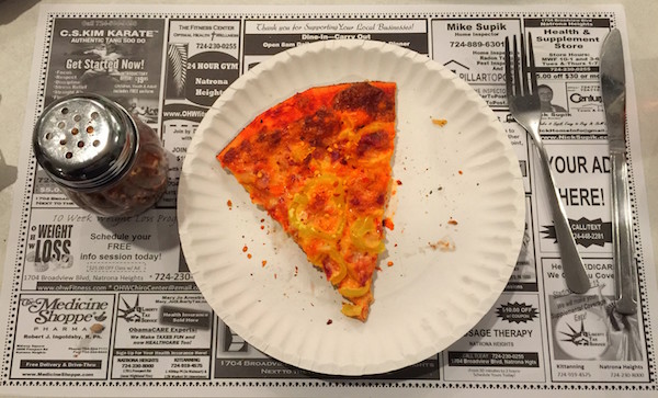 one slice pizza on paper plate with table setting