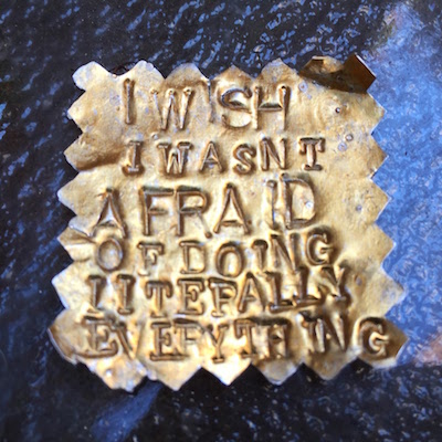 hand stamped metal with the text "I wish I wasn't afraid of doing literally everything"