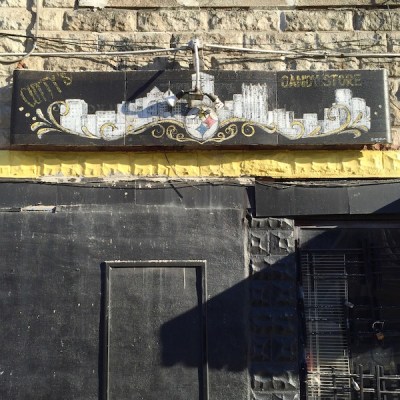 Sign for Cutty's Candy Store that includes the Pittsburgh skyline and a version of the Steelers logo with the word "Cutty" added