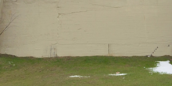 blank wall painted over to cover former ghost house and ghost sign at the site of the former Poli Restaurant, Pittsburgh, PA