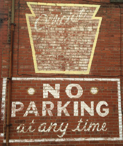 faded painting on brick wall reading "No Parking at any time", Glassport, PA