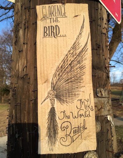 ink on cardboard street art of a bird with the text "Clarence the Bird...Make the world beautiful", Pittsbugh, PA