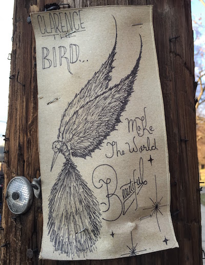 ink on cardboard street art of a bird with the text "Clarence the Bird...Make the world beautiful", Pittsbugh, PA