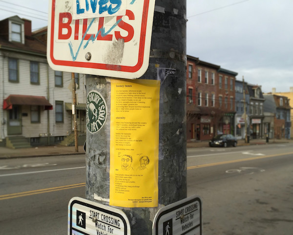Three of The Dirty Poet's poems taped to a light post, Pittsburgh, PA
