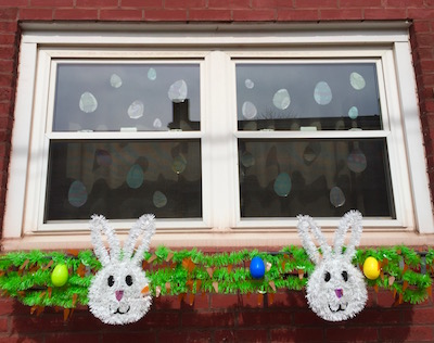 rowhouse windows decorated with Easter bunnies and eggs, Pittsburgh, PA