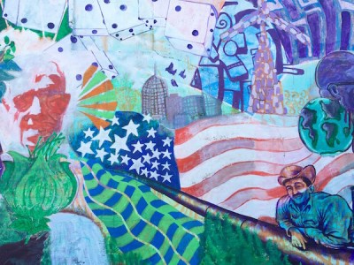 Mural detail showing waving abstract American flag with many other design elements including dice, city skyline, men, flowers, etc.