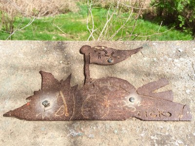 Cut out steel placard on the Polish Hill troll's concrete pedestal, Pittsburgh, PA