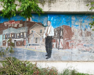 fading mural with businessman and exterior of Dipcraft Mfg. Co., Rankin, PA