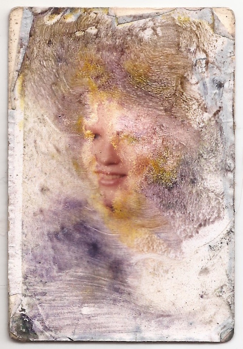 water-damaged wallet size photograph of an unknown girl