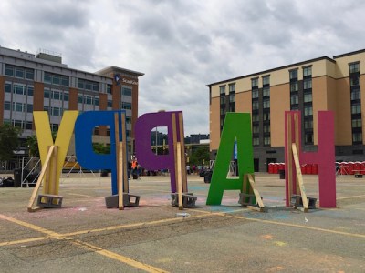 wooden letters that spell HAPPY, seen from behind