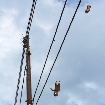 golden baby and baby foot hanging from wires, Pittsburgh, PA