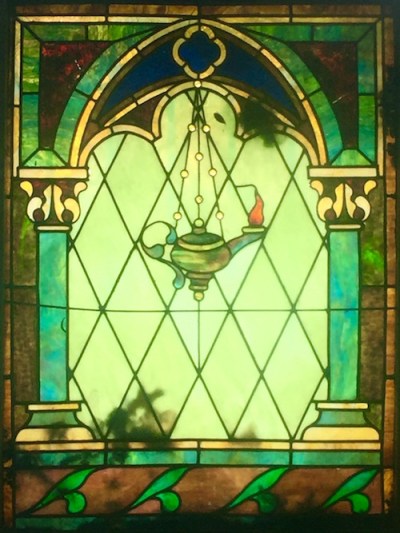 mausoleum stained glass of oil lamp hanging in arched window with columns, Allegheny Cemetery, Pittsburgh, PA