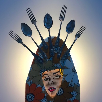 sculpture made from recycled ironing board, silverware, and advertising image by artist Karol Bergeret