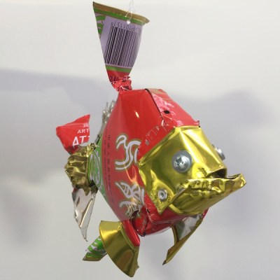 sculpture of red fish created from recycled metal can by artist Orson Buch