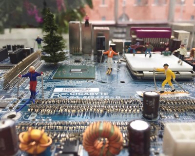 sculpture of tiny skiers on lanscape of recycled circuit board by artist David Martin