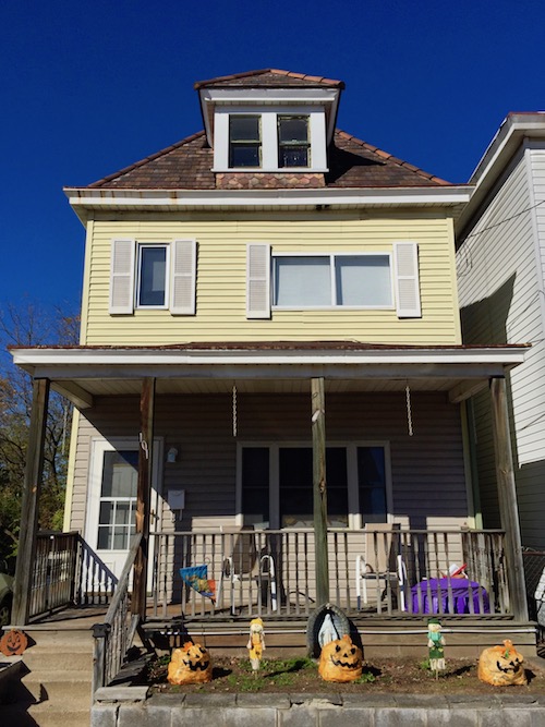Mary statue in grotto in front of frame house, Pittsburgh, PA