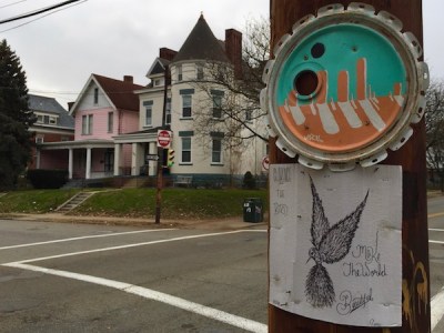 cardboard "Clarence the Bird ... Make the World Beautiful" artwork stapled to telephone pole, Pittsburgh, PA