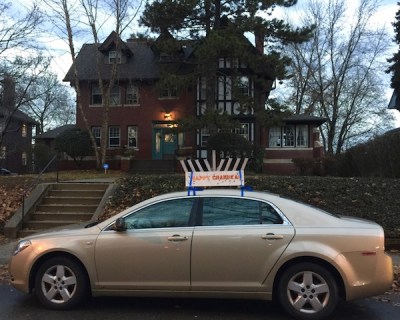 sedan with menorah and "Happy Chanukah" sign on roof, Pittsburgh, PA