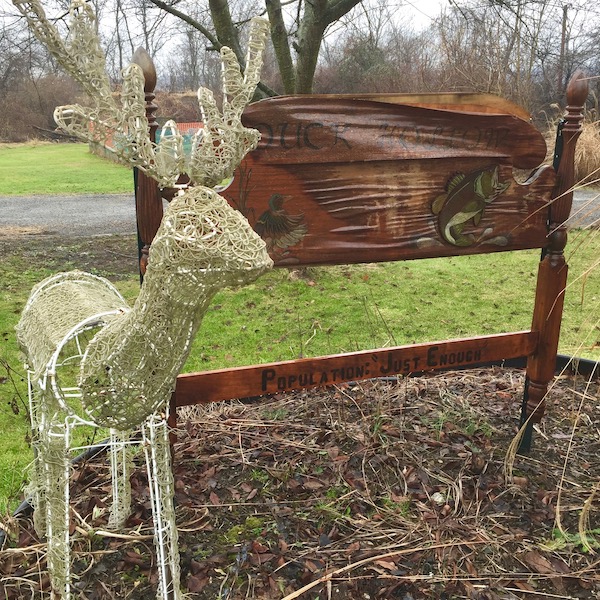 wooden bed headboard with the text "Duck Hollow. Population: 'Just Enough'", Pittsburgh, PA