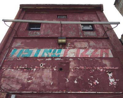 rear of commercial building with hand-painted sign reading "Astro Pizza", Pittsburgh, PA