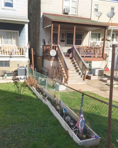 statuette of Mary in wooden backyard flower box, Pittsburgh, PA