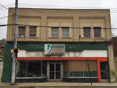 Brick commercial building with green, white, and red storefront, Clairton, PA