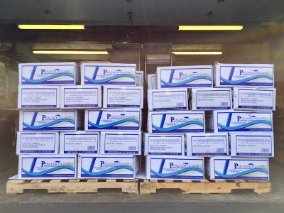 stacks of boxed frozen pollack fillets on shipping pallets