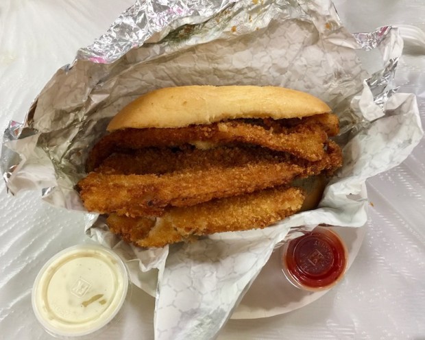 fish sandwich with three breaded fillets of fish from church fish fry