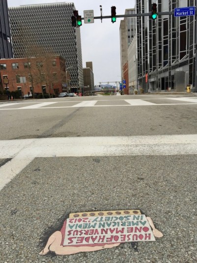 street art "Toynbee tile" and buildings of downtown Pittsburgh, PA