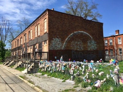boarded-up row houses and chain link fence decorated with stuffed animals, Pittsburgh, PA