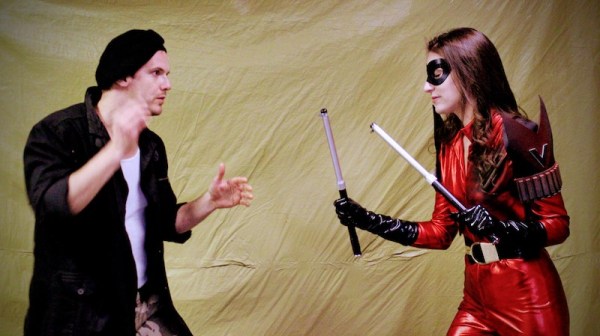 Heroine Vendetta attacks the bad guy with her escrima staves