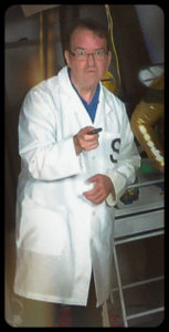 man in lab coat with evil scowl on his face