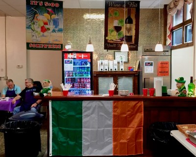 small bar in church basement decorated with flag and banners