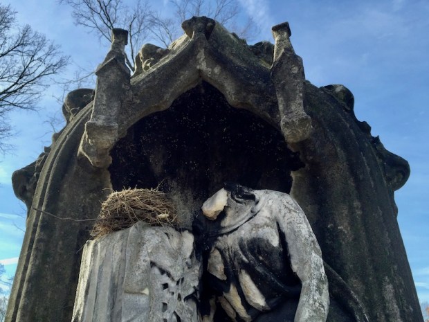 grave monument featuring two sculpted figures with both heads broken off, one of them has a bird's nest where the head would be, Allegheny Cemetery, Pittsburgh, PA