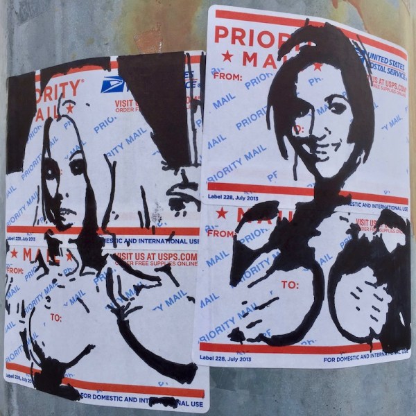 portraits of naked women holding their breasts drawn on US postal service mail labels and stuck to steel light pole, Pittsburgh, PA
