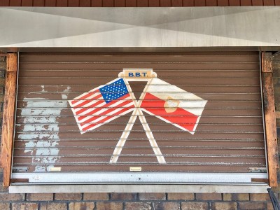 metal rolling window cover painted with crossed American and Polish flags, Pittsburgh, PA