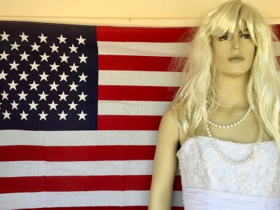 male mannequin dressed as a woman standing in front of American flag, Hawley, PA