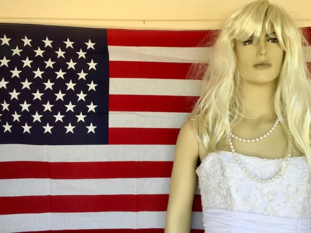 male mannequin dressed as a woman standing in front of American flag, Hawley, PA