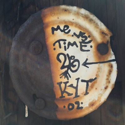 tin can lid painted with text "Me vs. Time, KYT, '02" nailed to telephone pole, Pittsburgh, PA